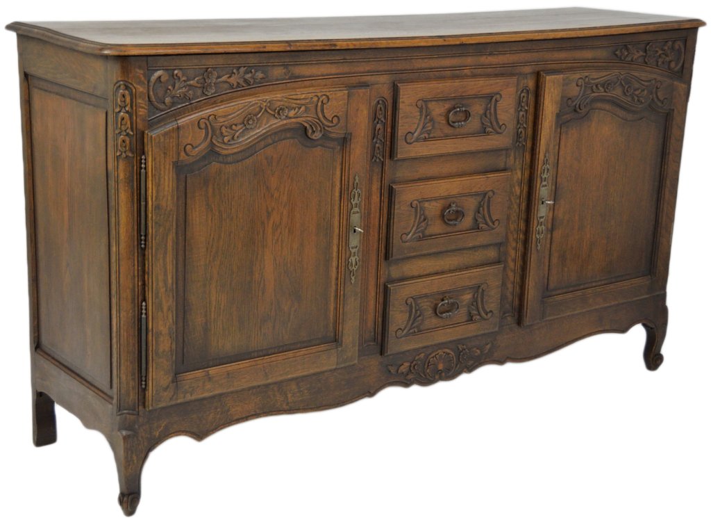 A LOUIS XV STYLE OAK BUFFET ENFILADE: A LOUIS XV STYLE OAK BUFFET ENFILADE Shaped doors with recessed panels accented by scrolled carvings flank a bank of three drawers with shapely carved panels. Supported on cabriole foot, with scallope