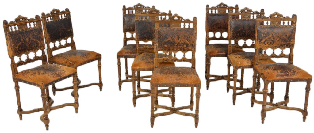A SET OF EIGHT RENAISSANCE REVIVAL STYLE SIDE CHAI: A SET OF EIGHT RENAISSANCE REVIVAL STYLE SIDE CHAIRS The backs having a spandrel of turned post supports, carved shell details, with turned tapered legs, having X base stretchers. Old tooled leather c