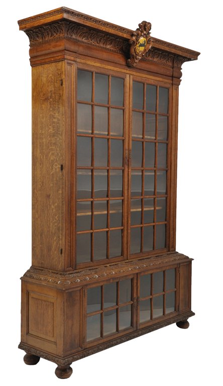A WILLIAM AND MARY STYLE OAK DOUBLE CABINET BIBLIO: A WILLIAM AND MARY STYLE OAK DOUBLE CABINET BIBLIOTHEQUE Early 20th Century The carved cornice with concave frieze features crisp hand-carved acanthus leaves supported by wide bolection moulding and p
