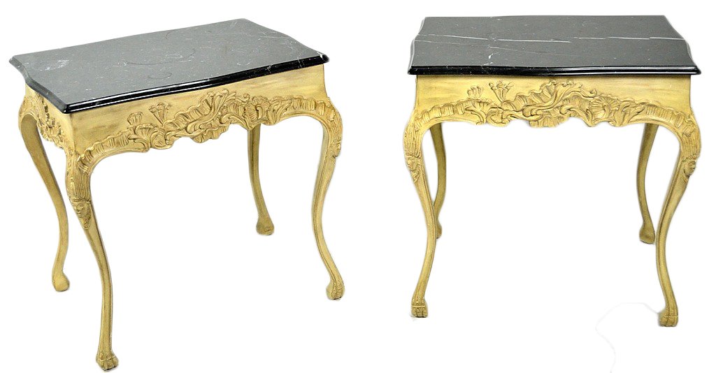 A PAIR OF FRENCH STYLE CARVED LAMP TABLES WITH MARB: A PAIR OF FRENCH STYLE CARVED LAMP TABLES WITH MARBLE TOPS The ornately carved and shaped aprons having a slight arch that form the exaggerated cabriole leg with maidens mask at the knee and paw foot.
