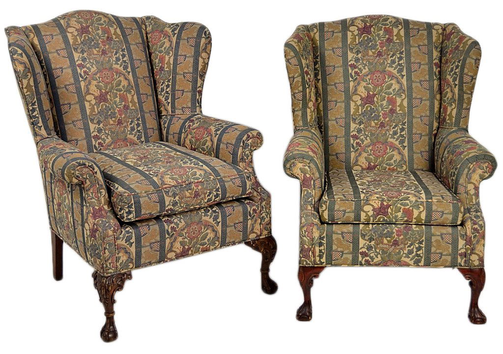A COMPANION PAIR OF CHIPPENDALE STYLE WINGBACK CHA: A COMPANION PAIR OF CHIPPENDALE STYLE WINGBACK CHAIRS Cabriole legs accented with carving and ball and claw feet. Loose cushion, newer floral stripe upholstery. 42½ x 32 x 30 inches