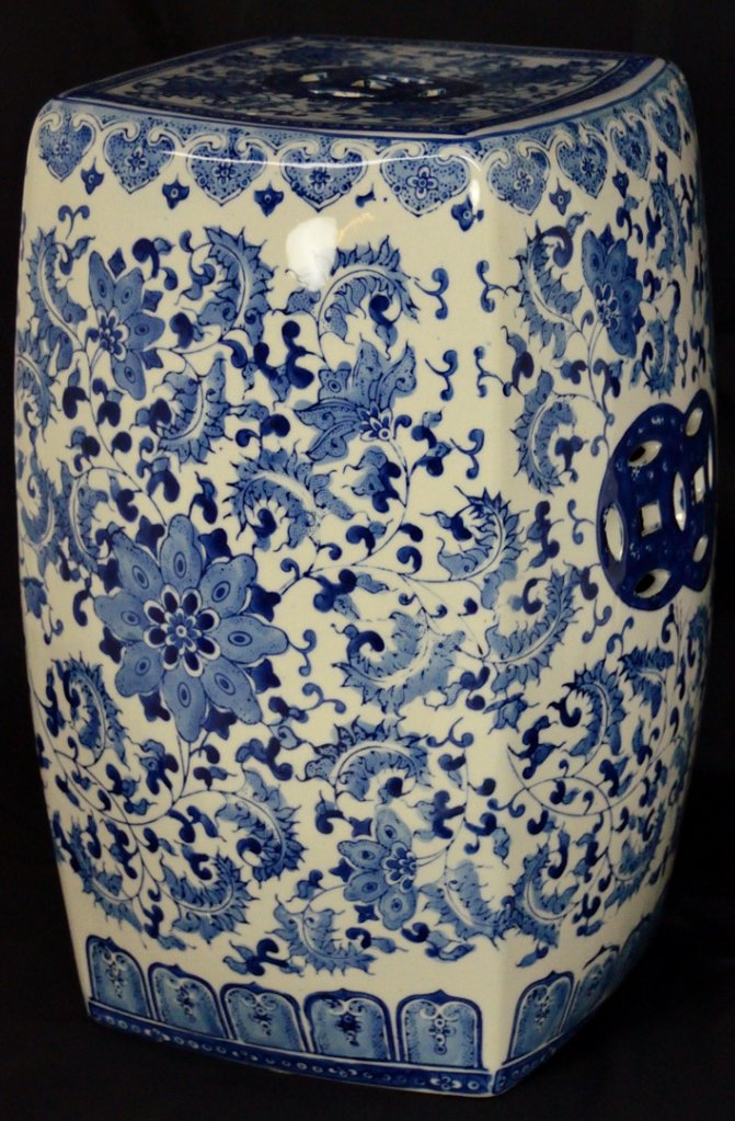 A CHINESE BLUE-AND-WHITE PORCELAIN GARDEN STOOL: A CHINESE BLUE-AND-WHITE PORCELAIN GARDEN STOOL 20th Century The four-sided stool decorated on two sides with a large flower embedded in a swirl of leaves, the top and other two sides having a pierced