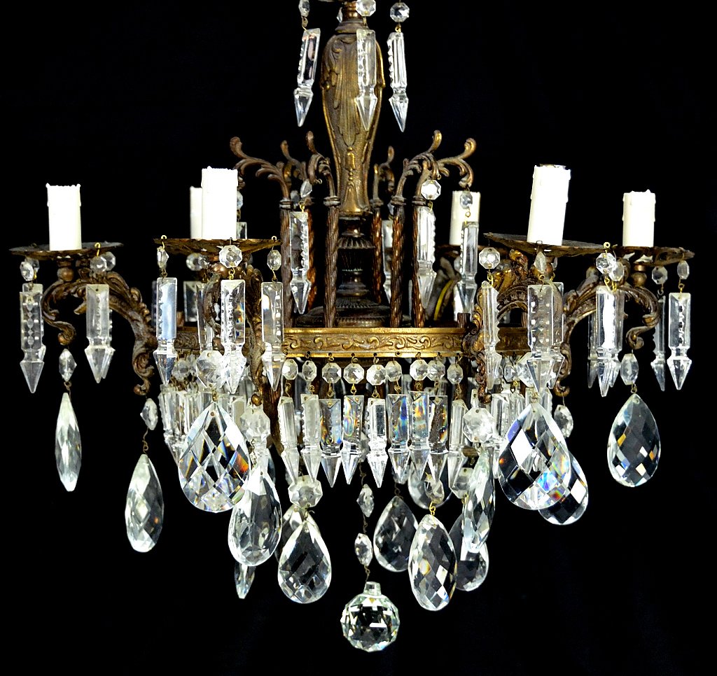 EMPIRE STYLE BRONZE AND CRYSTAL SIX LIGHT CHANDELIE: EMPIRE STYLE BRONZE AND CRYSTAL SIX LIGHT CHANDELIER Mid 20th Century , Italy Ornate bronze with central decorated circular frame hung with cut spear prisms, hexagon and large tear drops. 22½ x 21½ 
