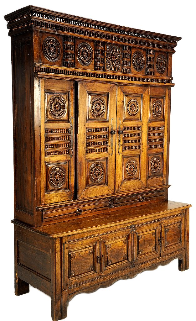 HAND CARVED BRITTANY STYLE WALNUT CABINET: HAND CARVED BRITTANY STYLE WALNUT CABINET 19th Century Sliding doors on the upper cabinet accented by pinwheels, panels and a spandral crown all of tiny turned vase form spools. Once a lift top bench,
