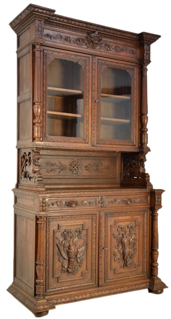 HENRI II STYLE CARVED WALNUT BUFFET: HENRI II STYLE CARVED WALNUT BUFFET 19th Century The buffet with arched view is masterfully hand carved in walnut. The door panels of the base cabinet feature intricately carved birds and a rabbit, al