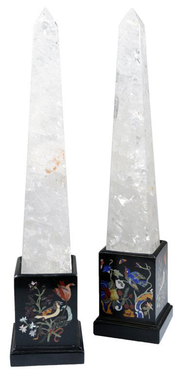 A PAIR OF ROCK CRYSTAL OBELISKS ON PIETRA DURA BASE: A PAIR OF ROCK CRYSTAL OBELISKS ON PIETRA DURA BASES 20th Century The rock crystal obelisks of typical form are supported by fitted black marble pedestals inlaid with semiprecious stones of lapis lazu