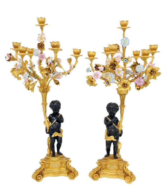 A PAIR OF PATINATED BRONZE AND BRONZE DORE SEVEN L: A PAIR OF PATINATED BRONZE AND BRONZE DORE SEVEN LIGHT CANDELABRA 20th Century Each of the seven floral candlecups are supported by a bobeche and acanthus branches with gilt bronze lilies and painted 