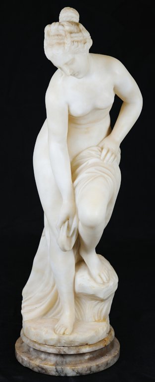 A NEOCLASSICAL STYLE ALABASTER FIGURE OF VENUS Con: A NEOCLASSICAL STYLE ALABASTER FIGURE OF VENUS Continental, Late 19th/Early 20th Century The finely carved figure of Venus is depicted with her left foot on a rock, wiping her calf after a bath, in th