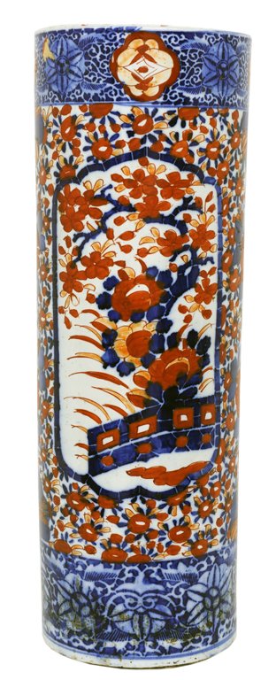 AN IMARI UMBRELLA STAND Japan, Meiji Period Very g: AN IMARI UMBRELLA STAND Japan, Meiji Period The cylindrical body with flat lip is adored with rust and cobalt floral decoration featuring reserves of blossoming cherry trees all on a white tin glazed 