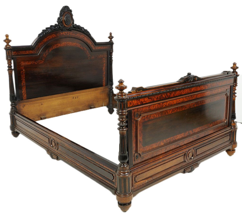 A NAPOLEON III STYLE CARVED ROSEWOOD AND BURL ELM: A NAPOLEON III STYLE CARVED ROSEWOOD AND BURL ELM BED 19th Century A carved and ebonized crest surmounts the arched rosewood headboard with burl elm inlay. Both the matching headboard and foot are fla