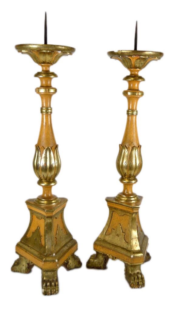 A PAIR OF LARGE GILT WOOD ALTAR CANDLESTICKS: A PAIR OF LARGE GILT WOOD ALTAR CANDLESTICKS Mid 20th Century Each with carved and gilded decoration on natural light wood; leaves encircle the top and bottom of the central post that rests on a trian
