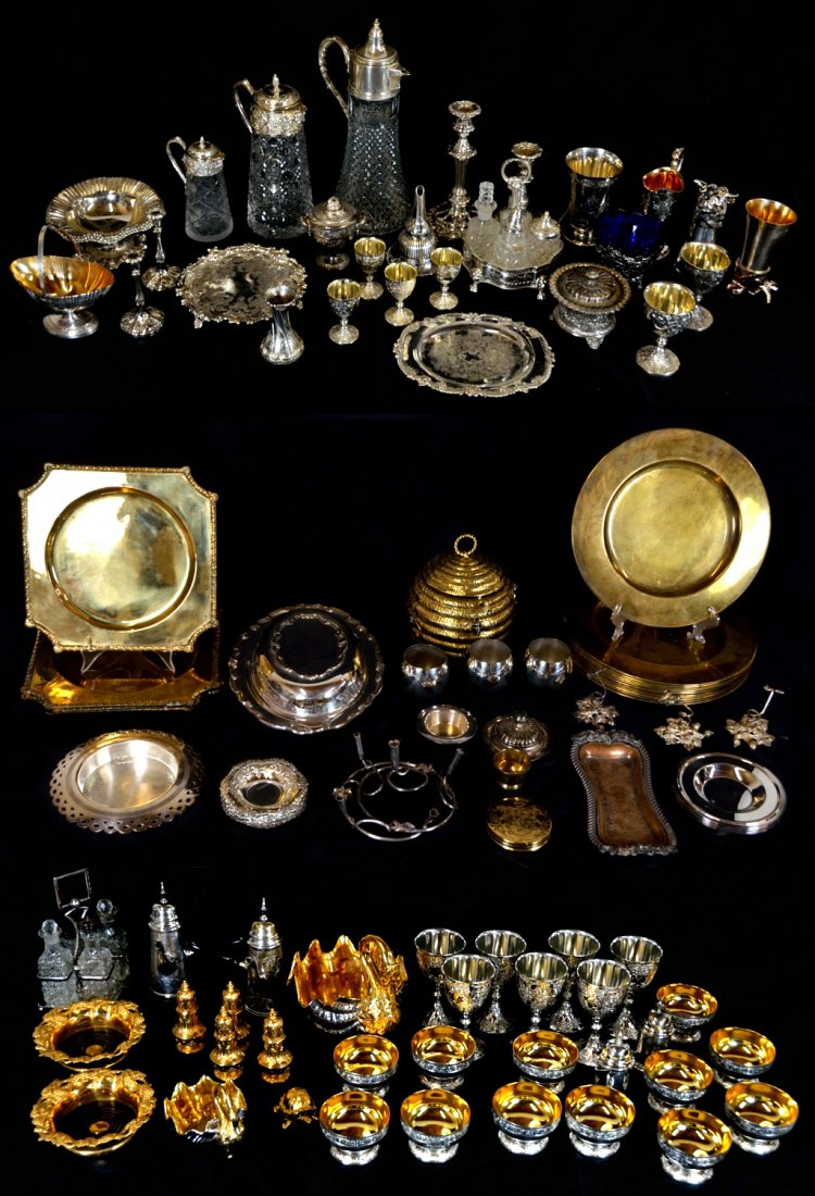 A LARGE GROUP OF SILVER AND GOLD PLATE TABLEWARE PL: A LARGE GROUP OF SILVER AND GOLD PLATE TABLEWARE PLUS EXTRAS 20th Century, Asia and USA The group inclusive of but not limited to; three graduated size glass and silver plate ewers, ornate goblets in 
