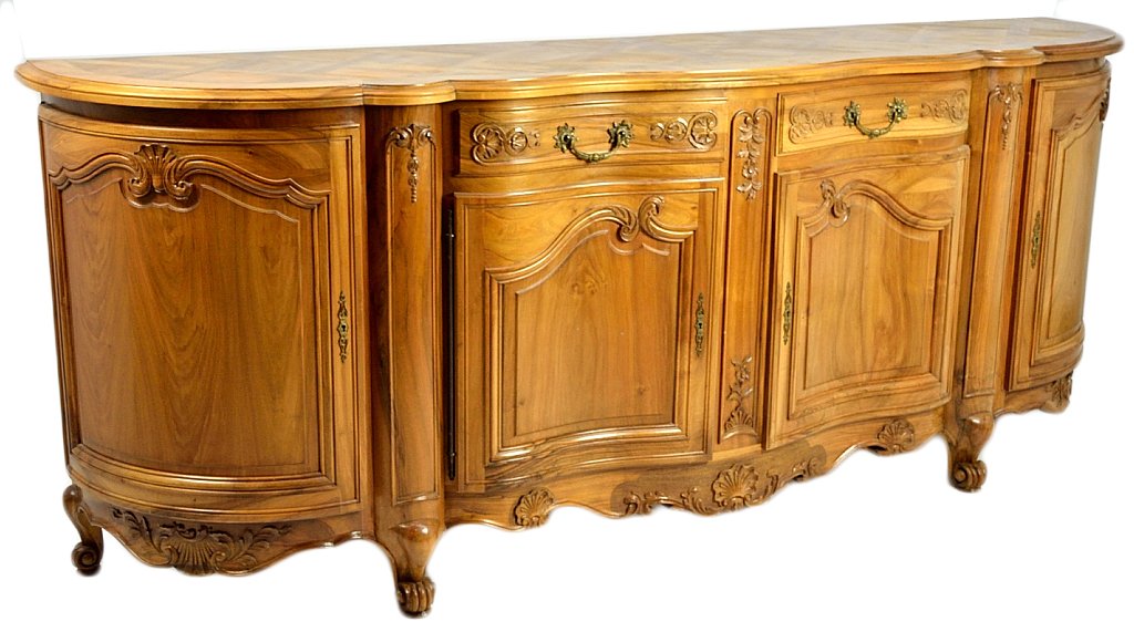 A LOUIS XV STYLE LIGHT WALNUT INFILADE: A LOUIS XV STYLE LIGHT WALNUT INFILADE Mid 20th Century A large carved walnut four door and two drawer buffet ""infilade"". The conforming shape top enhanced with basketweave parquetry. Floral and fol