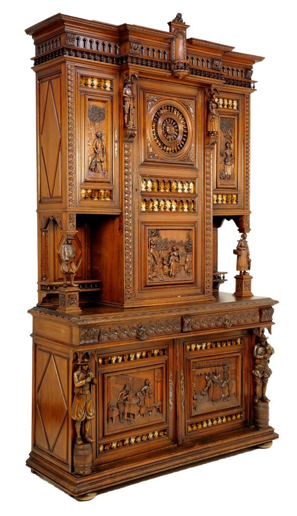 HEAVILY CARVED BRITTANY STYLE WALNUT CREDENZA: HEAVILY CARVED BRITTANY STYLE WALNUT CREDENZA 19th Century Heavily carved all over with scenic panels and regional figures, turned spindle grilles backed with velevet accent the carvings. A tiny cathe