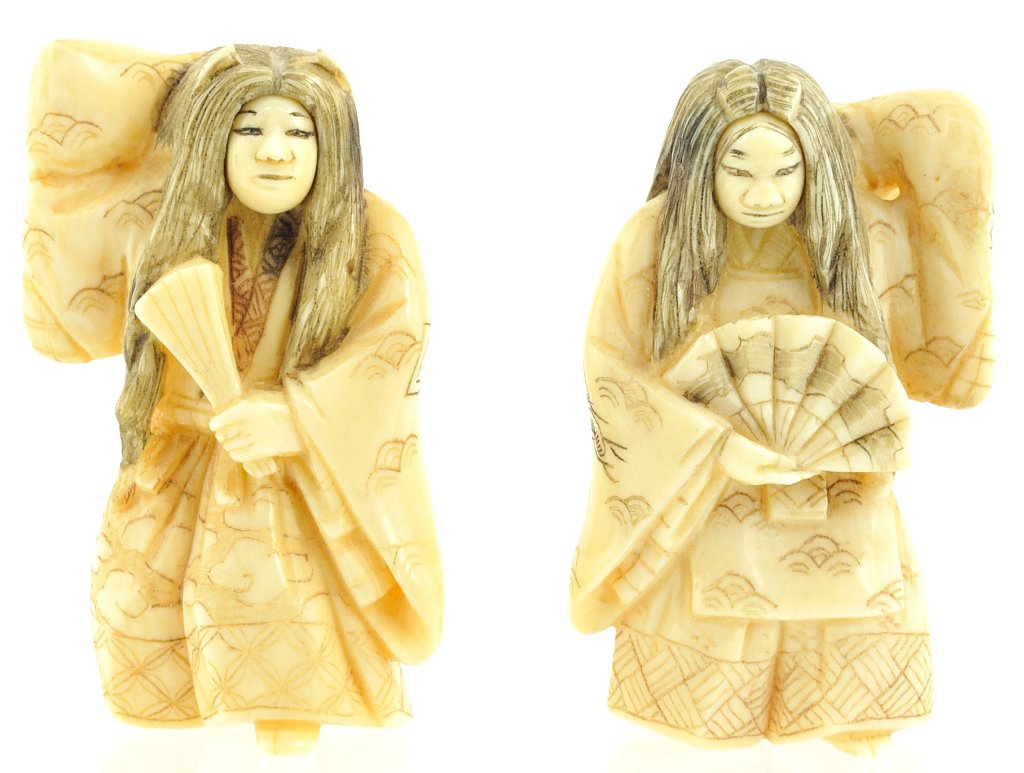 A PAIR OF JAPANESE FIGURAL IVORY NETSUKES; REVOLVI: A PAIR OF JAPANESE FIGURAL IVORY NETSUKES; REVOLVING HEADS Late 19th/early 20th century The two figures representing male and female Noh characters; the faces revolve to reveal theater masks, both dep