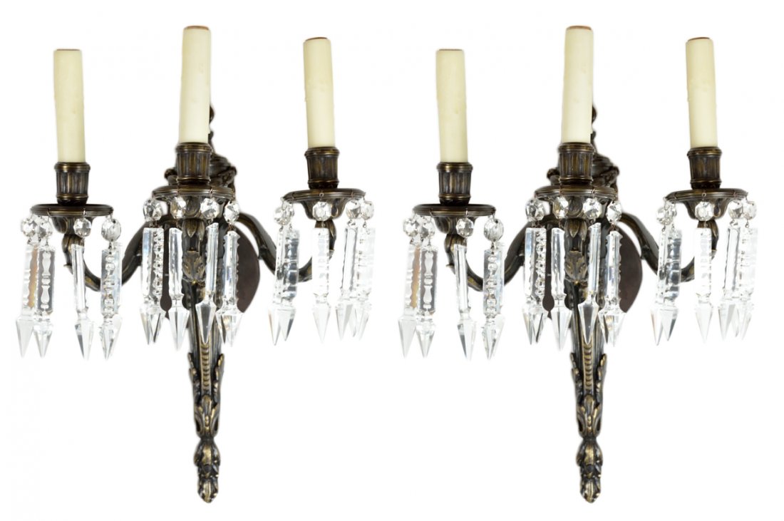 LOUIS XV STYLE THREE LIGHT BRONZE AND CRYSTAL SCON: LOUIS XV STYLE THREE LIGHT BRONZE AND CRYSTAL SCONCES 20th Century The central standard of urn form with foliate swag drape, terminating in an elongated spear covered in acanthus leaf. Dressed with an