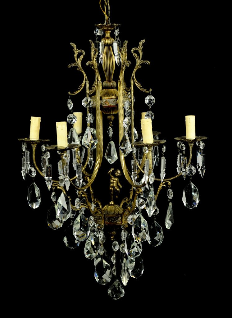VENETIAN GILT METAL AND CUT CRYSTAL CHERUB CHANDEL: VENETIAN GILT METAL AND CUT CRYSTAL CHERUB CHANDELIER Mid 20th Century 8 Light. Shapely gilt metal frame with dancing cherub at center. Dressed with kite cut prisms, crystal spears and large pear drop