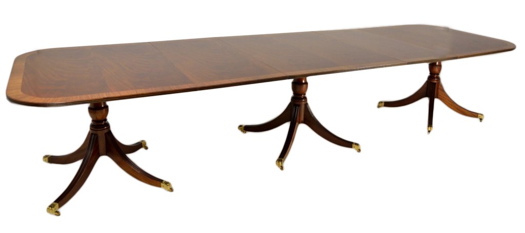 A SHERATON STYLE TRIPLE PEDISTAL MAHOGANY DINING: A SHERATON STYLE TRIPLE PEDISTAL MAHOGANY DINING 20th Century The top of book matched crotch grain mahogany with ribbon mahogany race track banding. Two leaves. 30 x 149½ x 48 inches