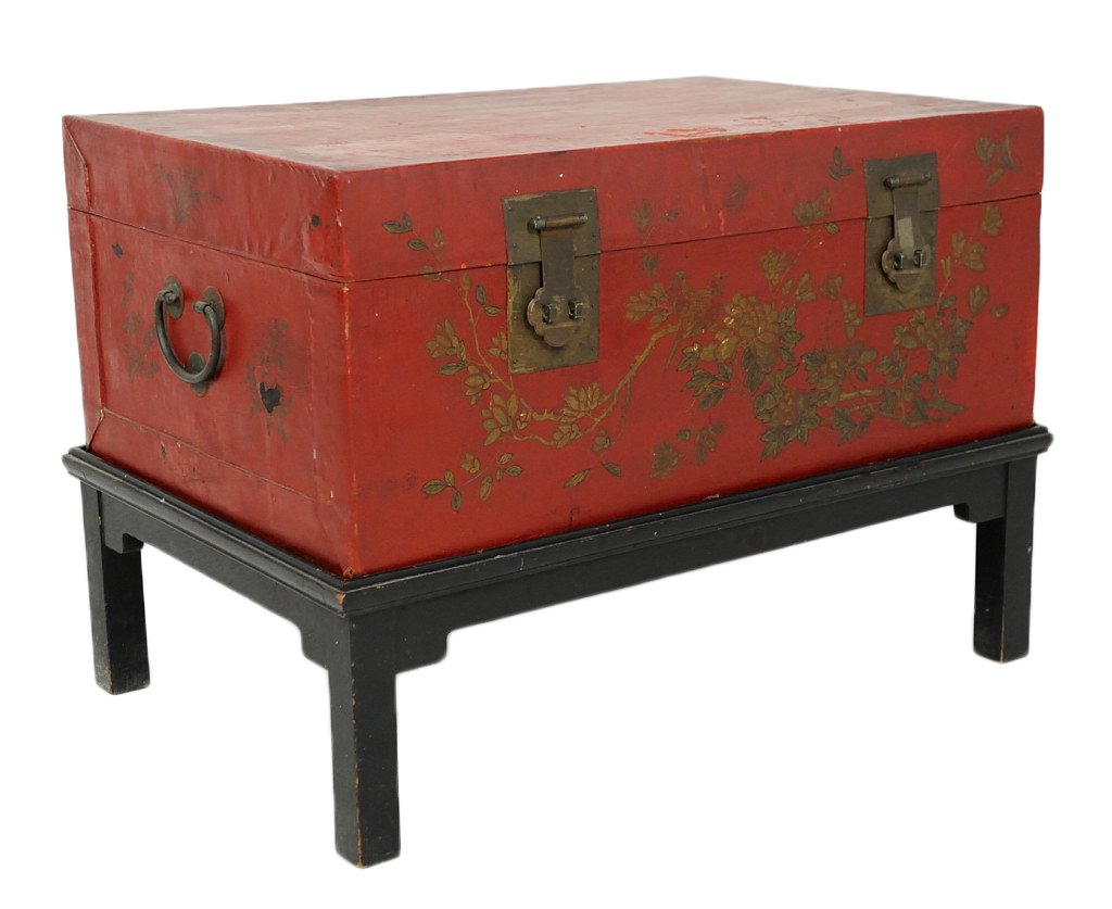 A CHINESE CINNABAR PAINTED PIGSKIN TRUNK ON STAND: A CHINESE CINNABAR PAINTED PIGSKIN TRUNK ON STAND 1st half 20th Century Gilt decorated with traditional bronze hardware in a fitted ebonized stand. 23½ x 34 x 23 inches