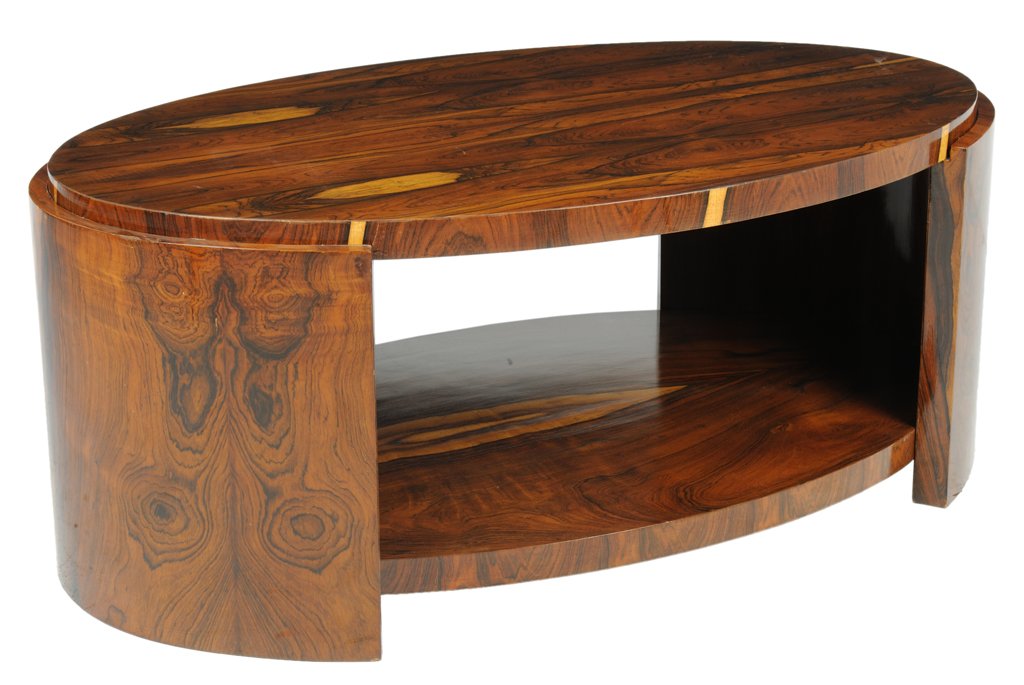 A DRAMATIC ART DECO STYLE MACASSAR EBONY ELLIPTICA: A DRAMATIC ART DECO STYLE MACASSAR EBONY ELLIPTICAL COFFEE TABLE 20th Century The bookmatched macassar ebony veneer runs the length of the ellipse and is supported by conforming full height supports a