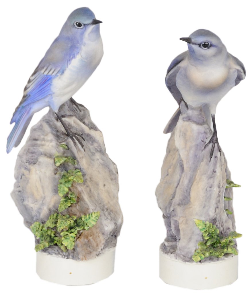 A PAIR OF DOROTHY DOUGHTY MOUNTAIN BLUEBIRDS: A PAIR OF DOROTHY DOUGHTY MOUNTAIN BLUEBIRDS England, 1964. Each Royal Worcester painted porcelain bird depicted perched on a rocky promontory with a few spleenwort Nigers growing in the crevices belo