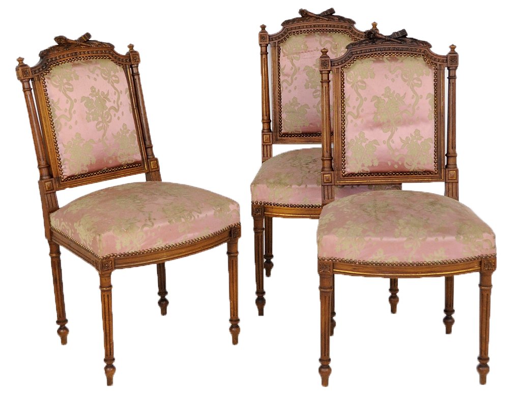 THREE ANTIQUE LOUIS XVI STYLE SIDE CHAIRS: THREE ANTIQUE LOUIS XVI STYLE SIDE CHAIRS Late 19th - Early 20th Century Three hand carved Louis XVI style walnut side chairs; the frames feature turned and carved legs, arms and uprights, all with fl