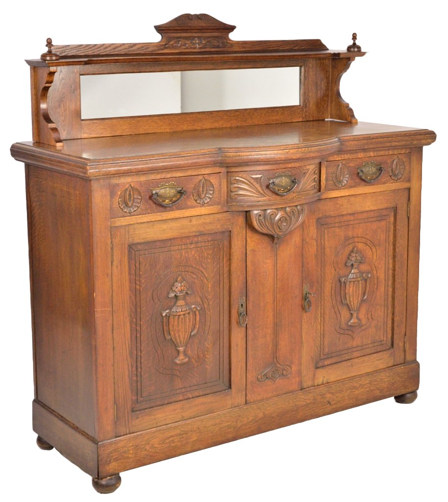 ANTIQUE VICTORIAN SIDEBOARD: ANTIQUE VICTORIAN SIDEBOARD 19th Century, Possibly American Solid Oak; carved and applied floral urns on lower doors, two flat carved and decorated flat front drawers flank a foliate carved bow front 