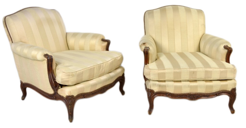 PAIR OF LOUIS XV STYLE WALNUT BERGERES: PAIR OF LOUIS XV STYLE WALNUT BERGERES Early 20th Century Walnut frames with carved floral and foliate accents in the reserves, tight backs with loose seat cushions. Rolled arm is possibly a later uph
