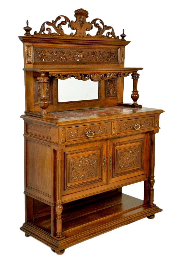 ANTIQUE FRENCH VICTORIAN SIDEBOARD: ANTIQUE FRENCH VICTORIAN SIDEBOARD 19th Century Solild Oak; heavily carved door and drawer panels with turned and fluted columns seperating each. Floral and foliate carved frieze panel with a pierce c