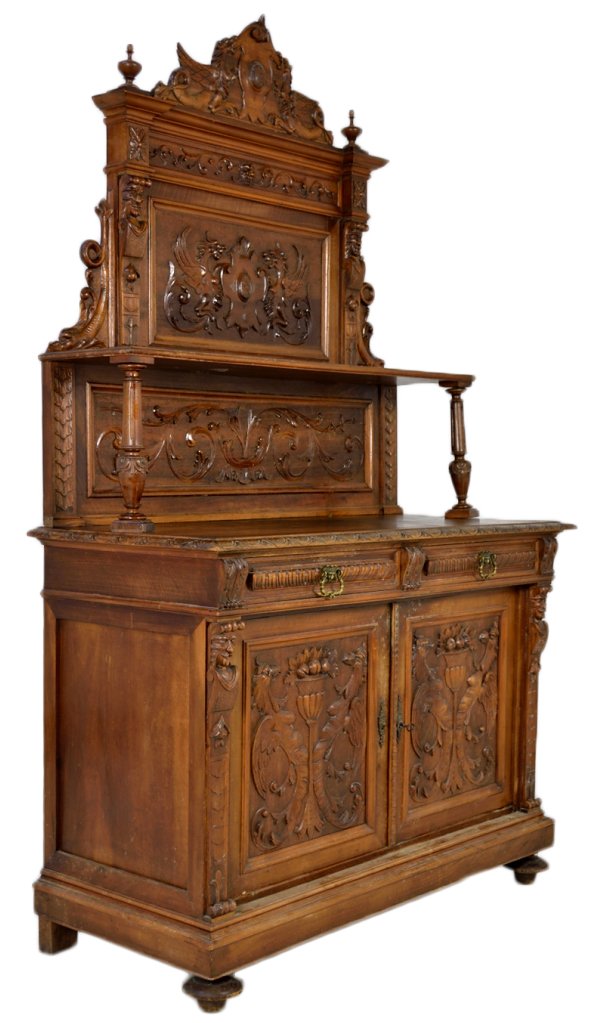 ANTIQUE FRENCH VICTORIAN SIDEBOARD: ANTIQUE FRENCH VICTORIAN SIDEBOARD 19th Century Solid Walnut; heavily carved double door and drawer base cabinet with elaborate tiered panel backsplash with shelf raised on turned posts. Carvings feat