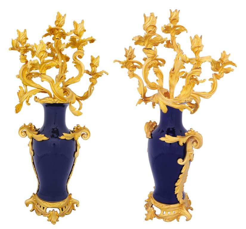 A DRAMATIC PAIR OF FRENCH DEEP COBALT PORCELAIN AN: A DRAMATIC PAIR OF FRENCH DEEP COBALT PORCELAIN AND BRONZE DORE SEVEN-LIGHT CANDELABRA 19th Century The Rococo style swirling bronze dore arms of finely cast bronze dore acanthus emanate from deep cob