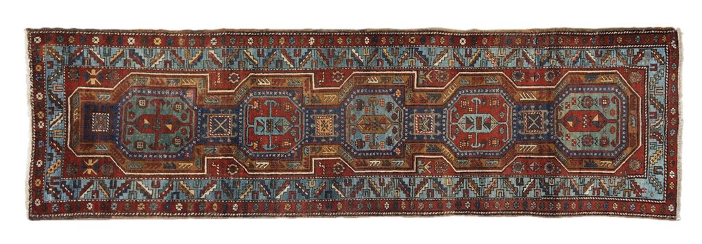 AN ANTIQUE HAND WOVEN PERSIAN HERIZ RUNNER Northwe: AN ANTIQUE HAND WOVEN PERSIAN HERIZ RUNNER Northwest Iran, Late 19th Century This runner shaped Heriz features complex geometric shape medallions. Complimentary corners and border echo the design. Sho