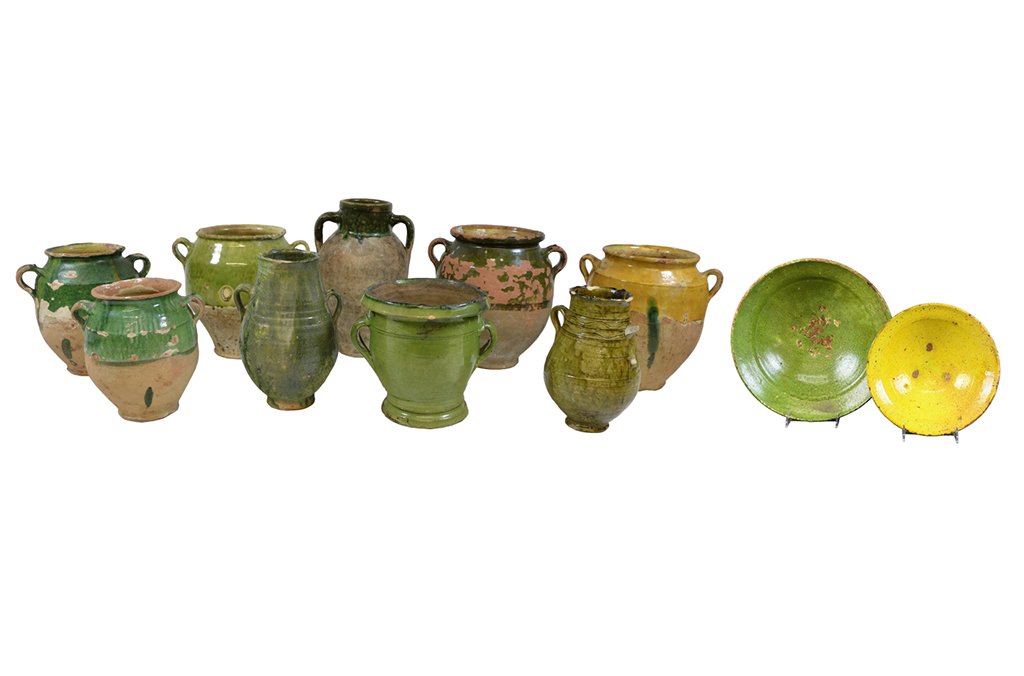 A GROUP OF GLAZED EARTHENWARE: A GROUP OF GLAZED EARTHENWARE 20th Century. The group consisting of nine heavy ceramic jars, each having two handles and glazed either entirely or on the upper half with green (8) or yellow (1); some