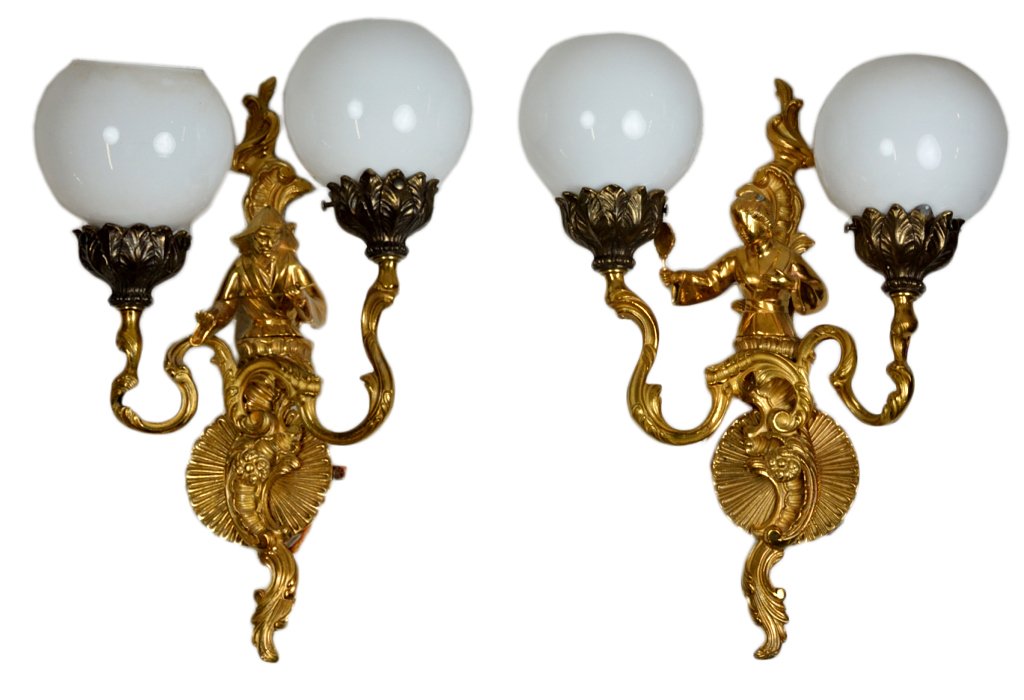 PAIR OF GILT BRONZE SCONCES: PAIR OF GILT BRONZE SCONCES 20th Century. Each two-light electrified sconce featuring a half-figure of a Chinese man or woman, the first holding a long pipe, the second a small mirror; each figure bac