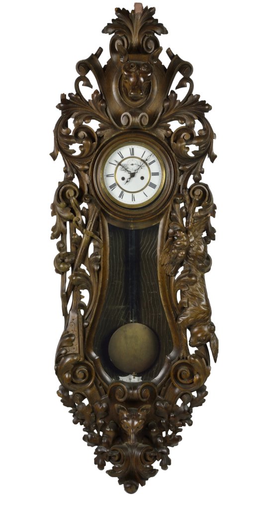 ANTIQUE CARVED BLACK FOREST CLOCK: ANTIQUE CARVED BLACK FOREST CLOCK The wall hung clock with elaborately pierce carved case featuring flora, fauna and wildlife, banjo shaped door glazing reveals the original brass pendulum, original R