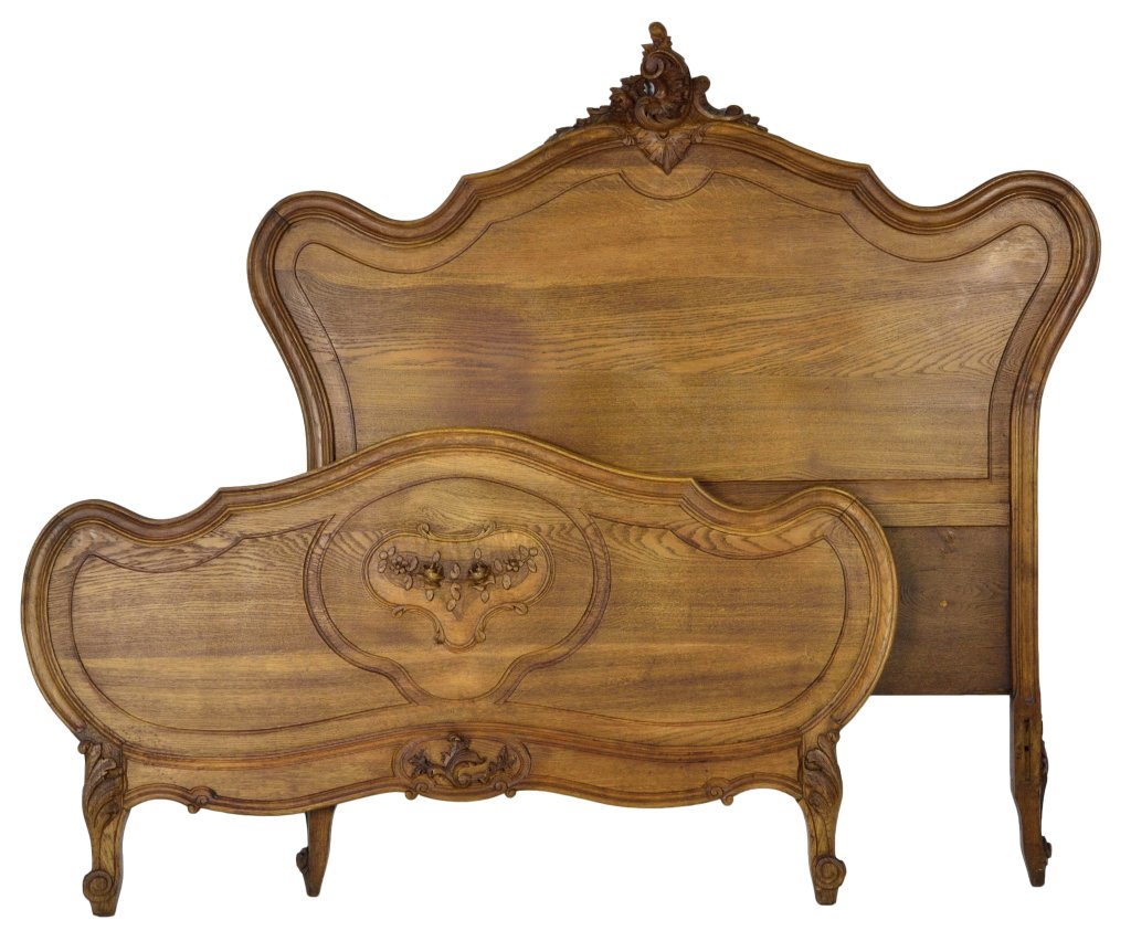 ANTIQUE LOUIS XV STYLE BED: ANTIQUE LOUIS XV STYLE BED France, Late 19th - Early Century Oak, arched shaping to both pieces, the head with a foliate carved decoration at center, the flat surface of the foot board is broken into 