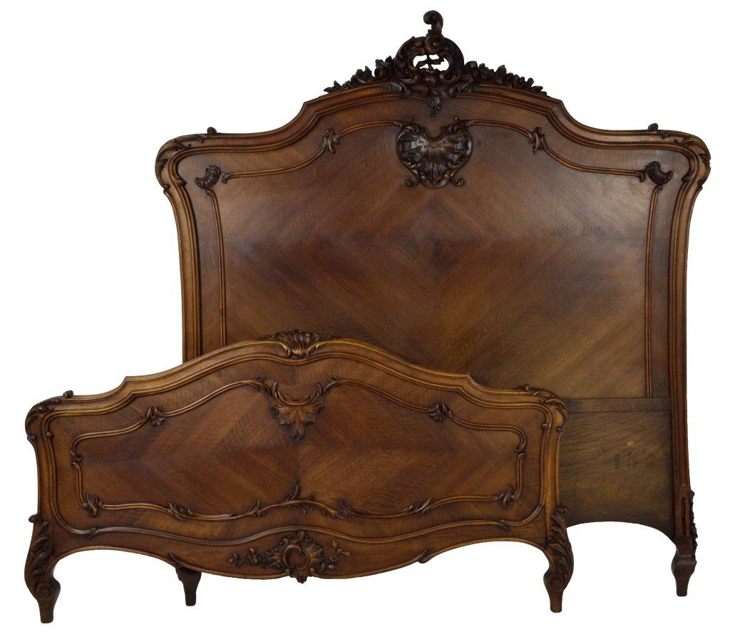 LOUIS XV STYLE CARVED BED: LOUIS XV STYLE CARVED BED France, 19th Century Walnut; shapely arched headboard with pierce carved encrusted crown, conforming shape central panel with roll carved edge molding, shaped foot board with