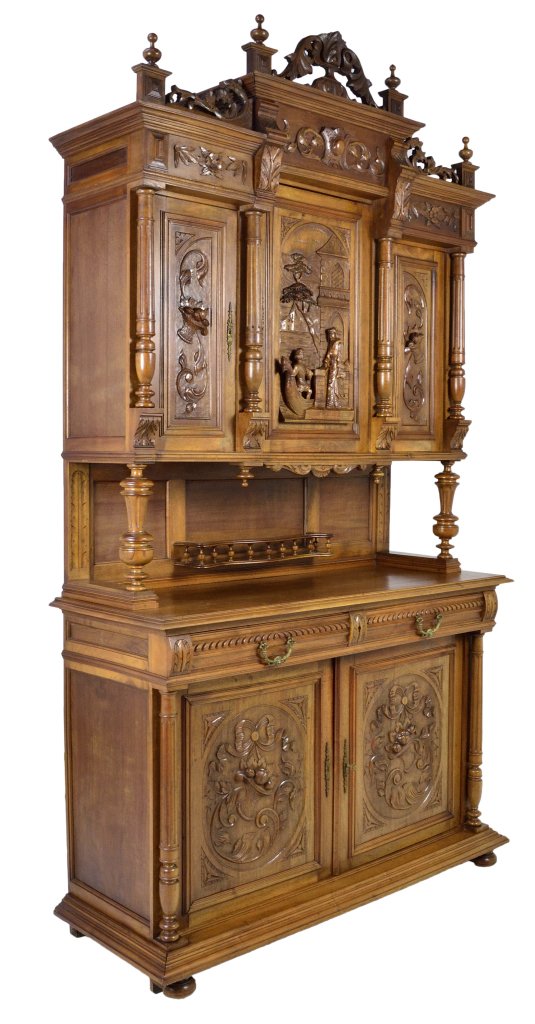 FRENCH VICTORIAN CARVED SIDEBOARD: FRENCH VICTORIAN CARVED SIDEBOARD 19th Century Walnut; relief carved baskets of fruit in paneled doors below, with pictorial carved central door above featuring a courting couple. Stepped center cupbo
