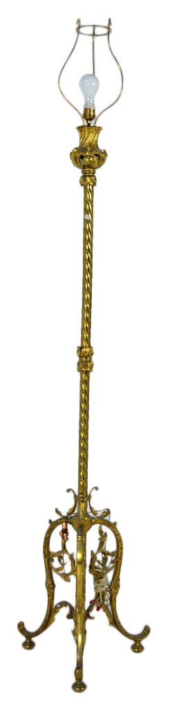 BRASS AND GILDED BRONZE FLOOR LAMP: BRASS AND GILDED BRONZE FLOOR LAMP Late19th Century, French The tall lamp featuring a brass pole in the form of a twisted rope supporting at the top a pierced gilded bronze vase-form with bosses, C-sc