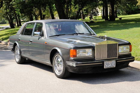 A 1990 ROLLS ROYCE SILVER SPUR II Crewe, Cheshire,: A 1990 ROLLS ROYCE SILVER SPUR II Crewe, Cheshire, England, UK 1990 Rolls Royce Silver Spur II four door saloon sedan, dark pewter exterior with red Connolly leather hides, burl walnut wood trim inter