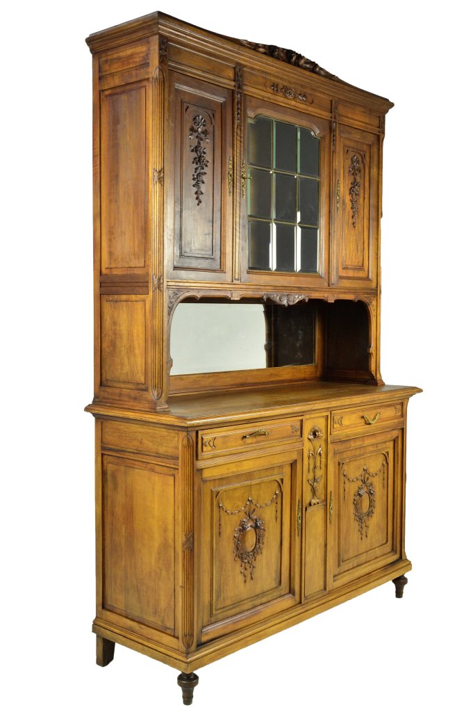 LOUIS XVI STYLE BUFFET: LOUIS XVI STYLE BUFFET Late 19th - 20th Century Grand scale buffet with slight arch at crown, features hollowed flower buds carved in high relief and acorn garland. Stylized reeding and step molding o