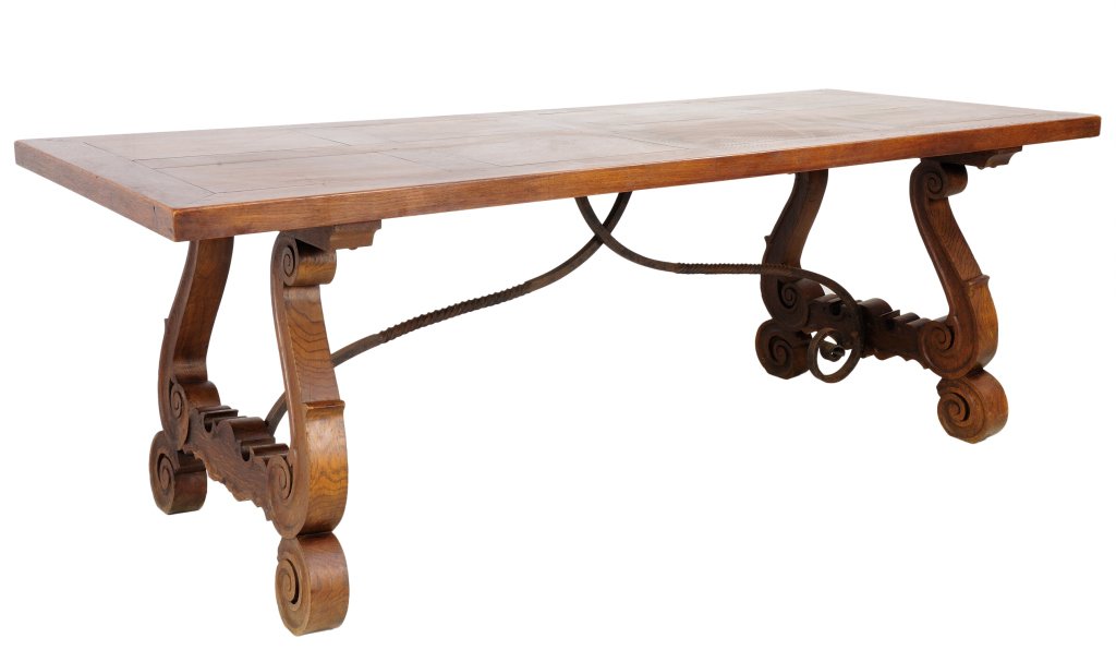 ANTIQUE SPANISH OAK DINING TABLE: ANTIQUE SPANISH OAK DINING TABLE Late 19th - Early 20th In the traditional Spanish style with wood blocking on table top, the table is supported by two carved lyre uprights with scrolling details, and