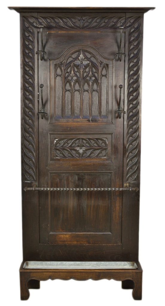 A GOTHIC STYLE COAT RACK WITH IRON MOUNTS: A GOTHIC STYLE COAT RACK WITH IRON MOUNTS 19th Century, France This hand carved 19th century gothic style hand carved oak coat rack of raised panel construction has a carved foliate edge, four wrought