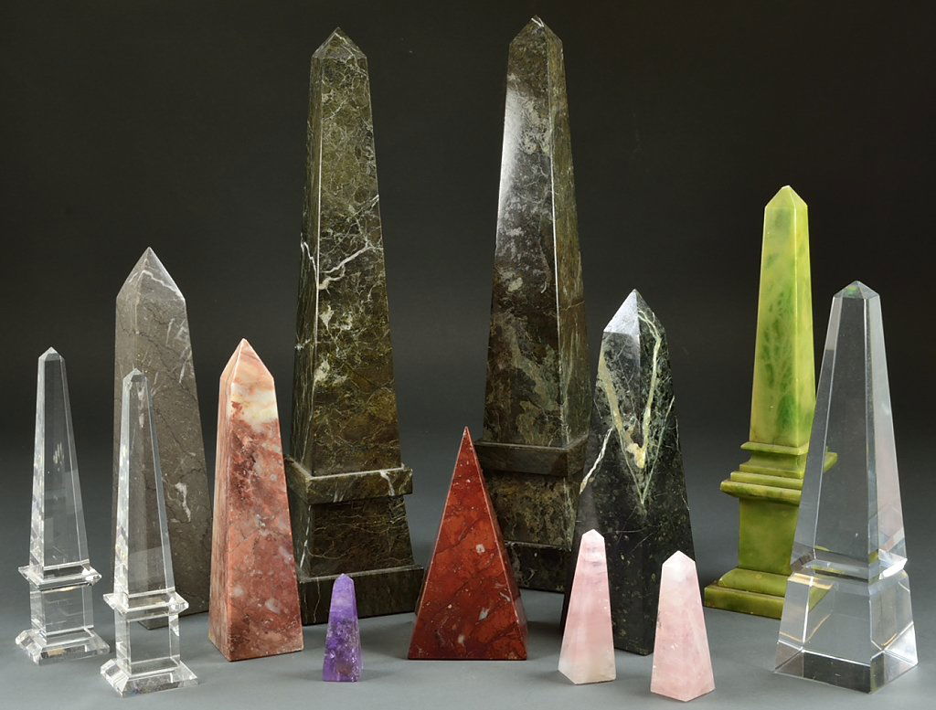 A GROUP OF STONE, CRYSTAL AND GLASS OBELISKS: A GROUP OF STONE, CRYSTAL AND GLASS OBELISKS 20th Century A group of cut stone and glass obelisks includes three large green stone obelisks, three medium sized obelisks in varying colors such as black