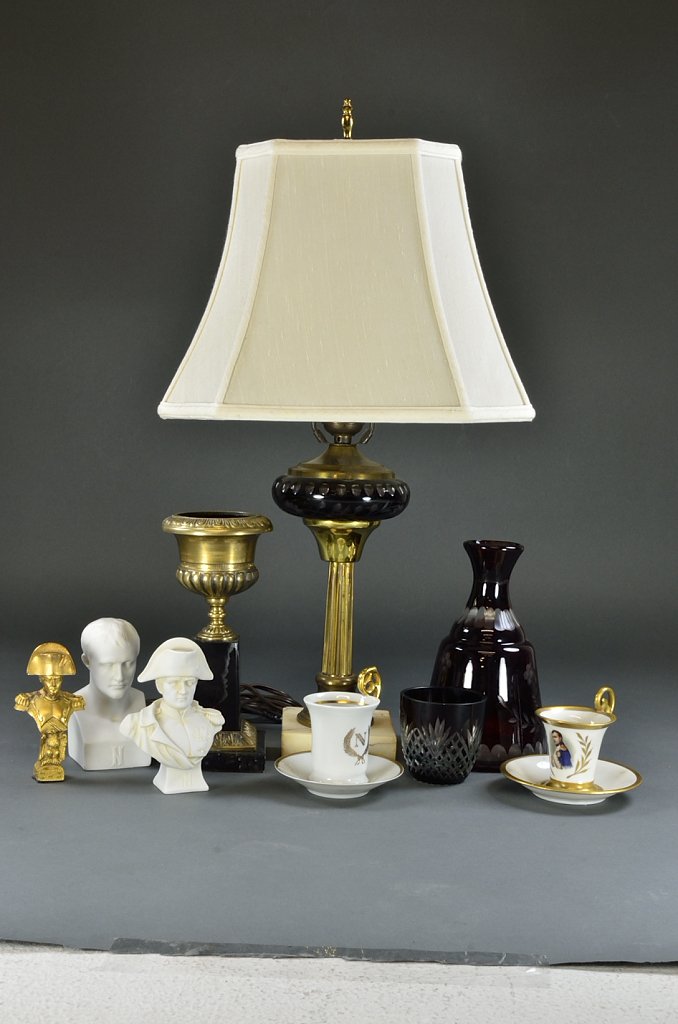 A FINE NAPOLEON COLLECTION WITH VINTAGE RED GLASS : A FINE NAPOLEON COLLECTION WITH VINTAGE RED GLASS DECANTER SET 20th Century A grouping of design elements includes two Napoleon themed demi cup and saucers, an urn on marble base, two busts of Napoleo