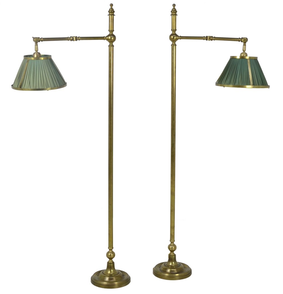 A PAIR OF VINTAGE BRASS SWING ARM FLOOR LAMPS: A PAIR OF VINTAGE BRASS SWING ARM FLOOR LAMPS First half 20th Century A vintage pair of brass reading lamps, having a finial top, with ball details, a brass frame with jointed arms support original gr