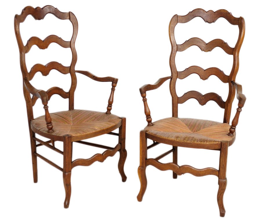 A FINE PAIR OF LOUIS XV PROVINCAL STYLE ARMCHAIRS: A FINE PAIR OF LOUIS XV PROVINCAL STYLE ARMCHAIRS 19th Century, France A duo of antique French Provencal style arm chairs, with scallop carved ladder backs, hand carved armrests that pierce a woven ru
