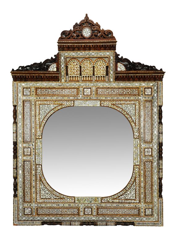 A LAVISH MOORISH MOTHER OF PEARL AND BONE INLAID MI: A LAVISH MOORISH MOTHER OF PEARL AND BONE INLAID MIRROR Third Quarter 20th Century The architectural body of the mirror features a stepped cornice with a frieze of arches inlaid with mother of pearl i