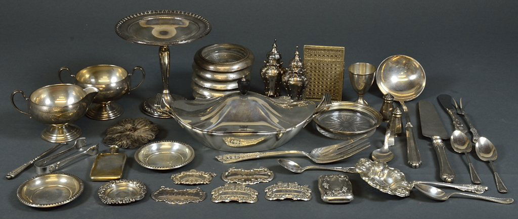 A GROUPING OF ANTIQUE AND VINTAGE STERLING SILVER: A GROUPING OF ANTIQUE AND VINTAGE STERLING SILVER Early - Mid 20th Century A grouping of forty antique and vintage silver including trays, lidded vessels, liquor bottle labels, utensils, coasters, and