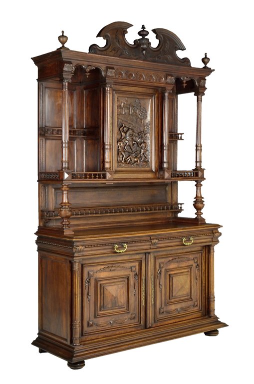 A FRENCH VICTORIAN HENRI II STYLE WALNUT BUFFET WITH CA: A FRENCH VICTORIAN HENRI II STYLE WALNUT BUFFET WITH CASTLE Late 19th - Early 20th Century A fine walnut buffet is crowned with a bonnet top with carved, stepped acanthus frieze; flanked by finials an